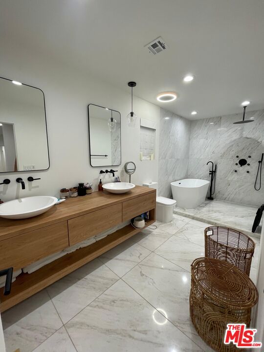 bathroom with vanity, independent shower and bath, and tile walls