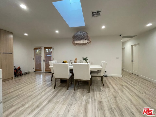 dining area with light hardwood / wood-style flooring and french doors