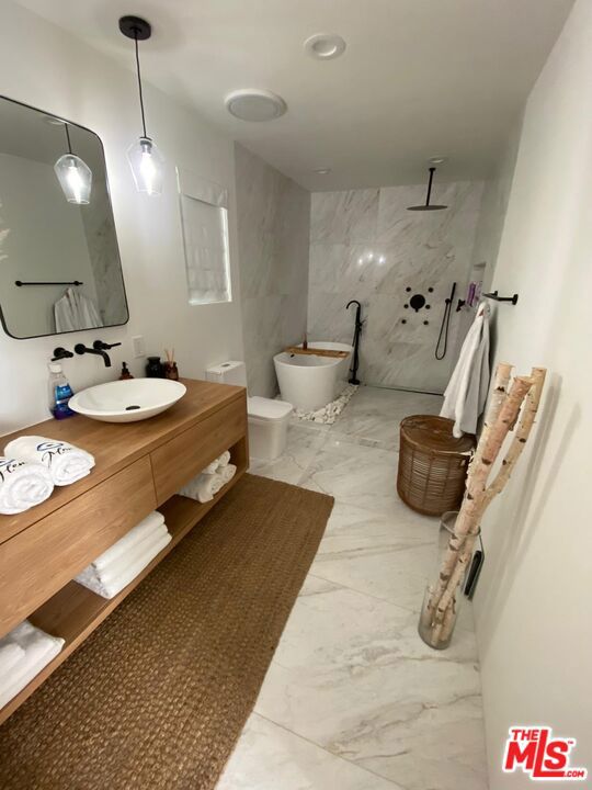 bathroom with vanity and a shower