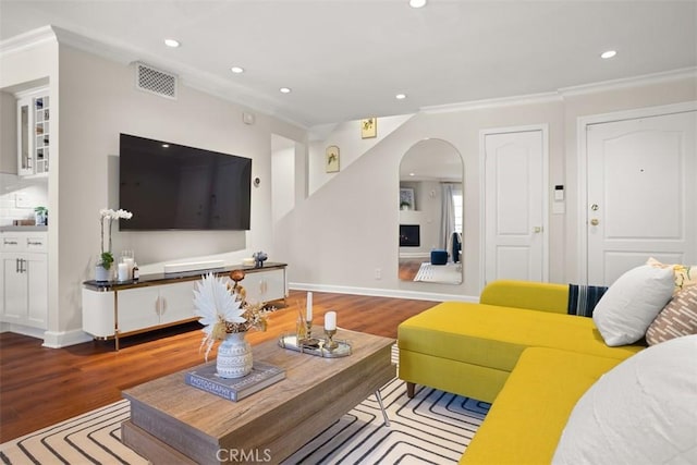 living room with hardwood / wood-style flooring and crown molding