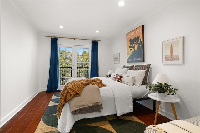 bedroom with access to exterior, crown molding, dark hardwood / wood-style floors, and french doors