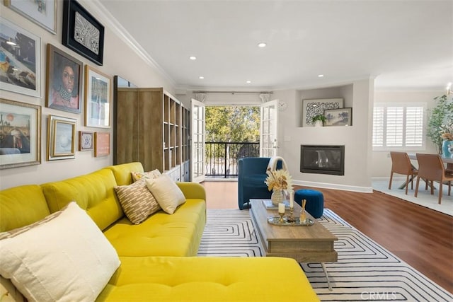 living room featuring wood-type flooring and ornamental molding