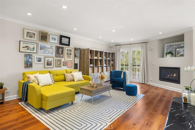 living room with crown molding, hardwood / wood-style floors, and french doors