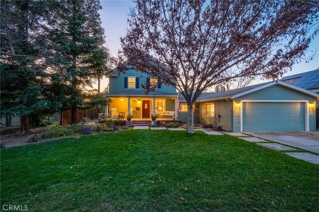 view of front of property with a garage, covered porch, and a lawn