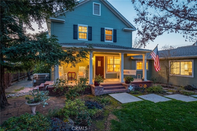 front facade featuring a jacuzzi and covered porch