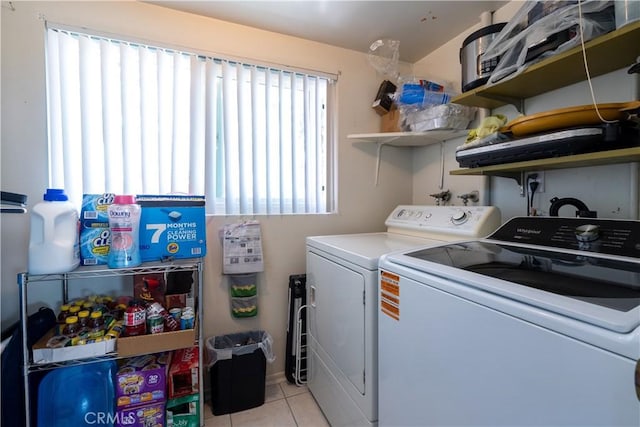 laundry room with light tile patterned floors and washing machine and clothes dryer