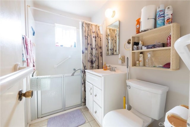 bathroom with vanity, tile patterned floors, toilet, and walk in shower