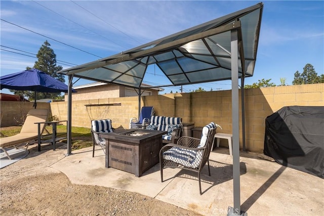 view of patio / terrace with grilling area and a fire pit