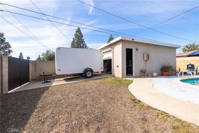 back of house featuring a fenced in pool and a patio