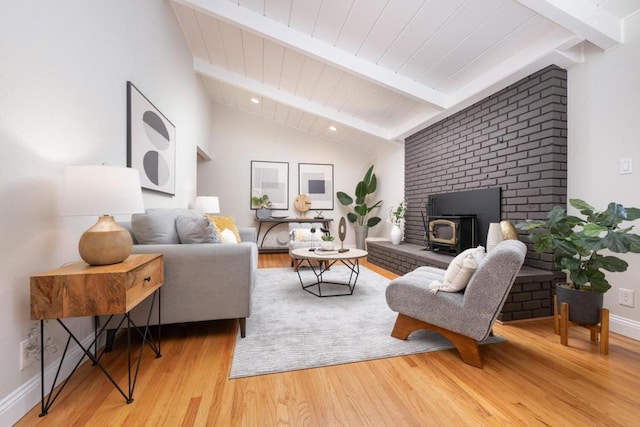 living room with vaulted ceiling with beams and wood-type flooring