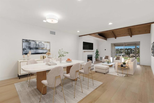 dining room featuring wood ceiling, beam ceiling, and light hardwood / wood-style flooring