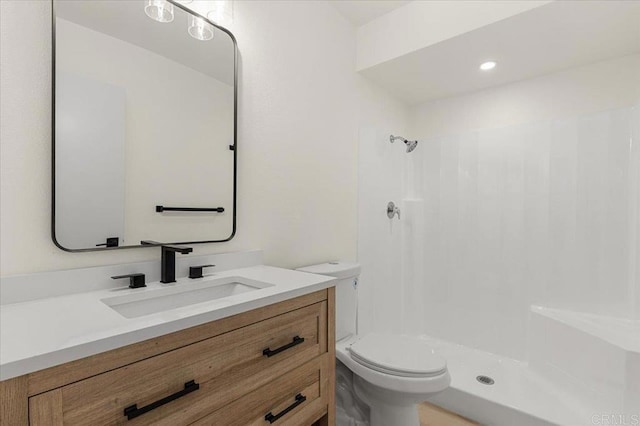 bathroom with vanity, toilet, and walk in shower