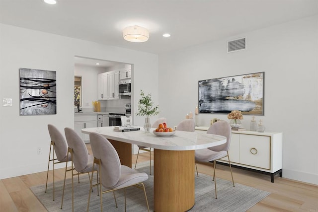 dining area with light hardwood / wood-style floors