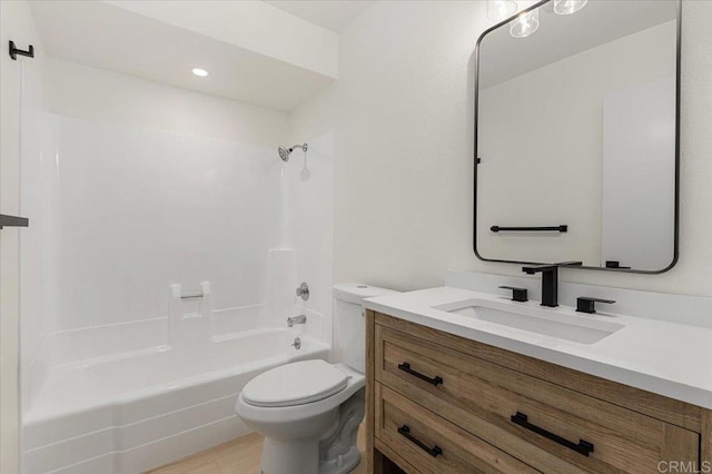 full bathroom with vanity, washtub / shower combination, and toilet