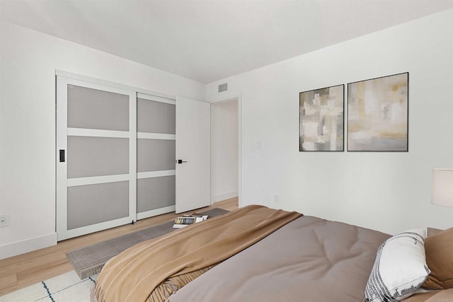 bedroom with a closet and light wood-type flooring