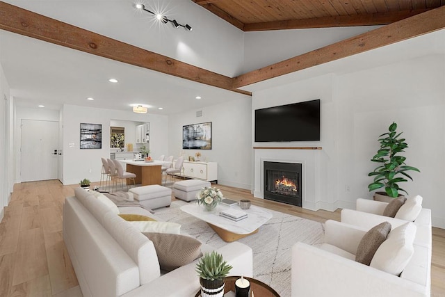 living room featuring vaulted ceiling with beams, wood ceiling, and light hardwood / wood-style floors