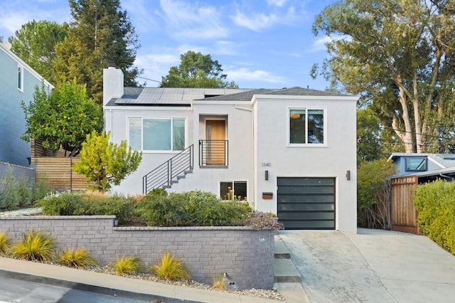 modern home featuring a garage and solar panels