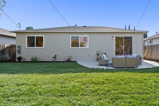 rear view of house featuring a yard, an outdoor hangout area, and a patio area