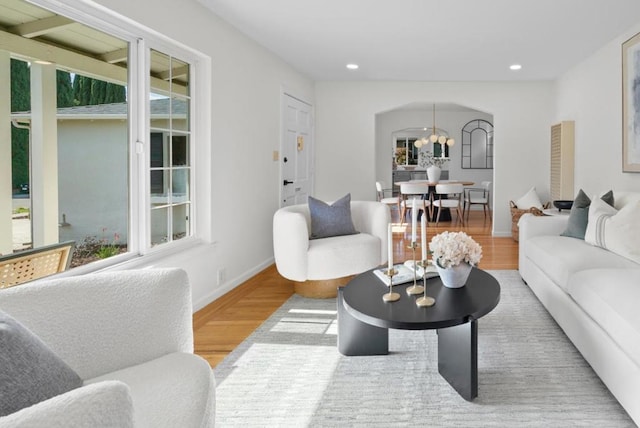 living room featuring wood-type flooring and a chandelier