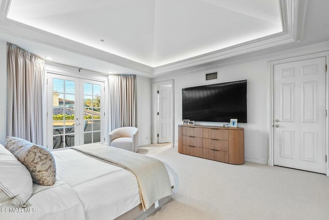 bedroom with french doors, a tray ceiling, light carpet, and access to outside