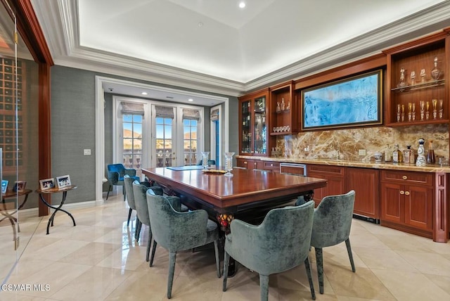 dining area featuring bar, crown molding, and french doors