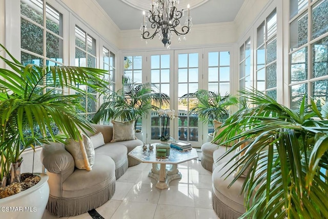 sunroom featuring an inviting chandelier and a healthy amount of sunlight