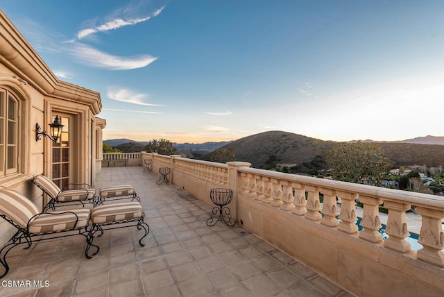 balcony at dusk with a mountain view