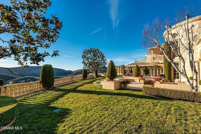 view of yard with a mountain view and a patio area