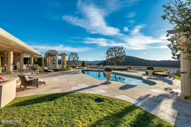 view of pool with a mountain view, a hot tub, and a patio