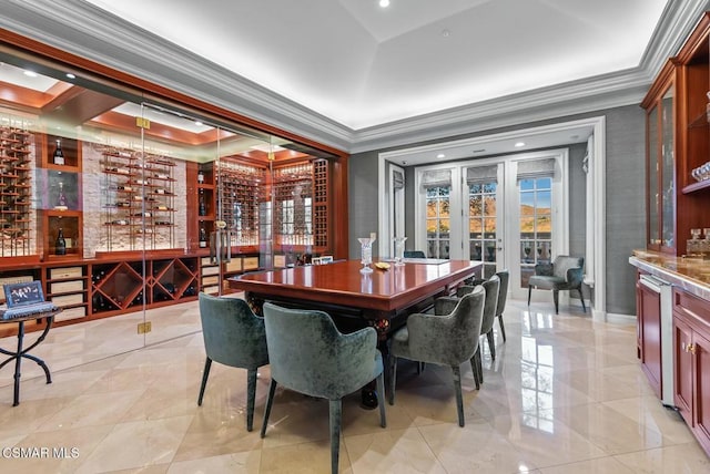 dining space with a tray ceiling, ornamental molding, and french doors