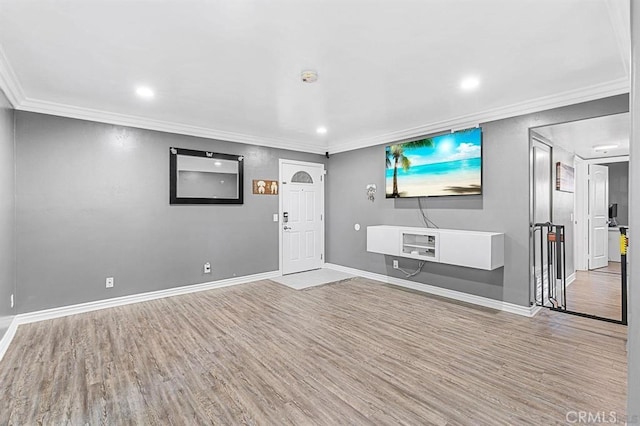 unfurnished living room featuring crown molding and light hardwood / wood-style flooring