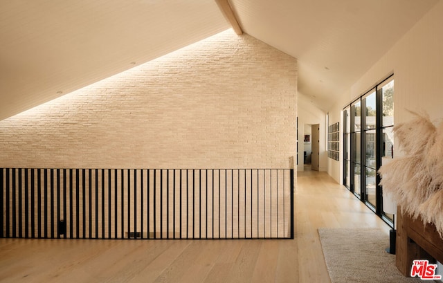 corridor with beam ceiling, high vaulted ceiling, and light wood-type flooring