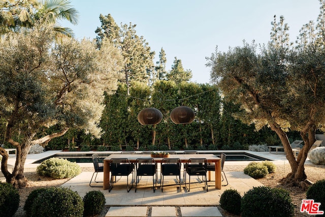 view of home's community with a swimming pool and a patio