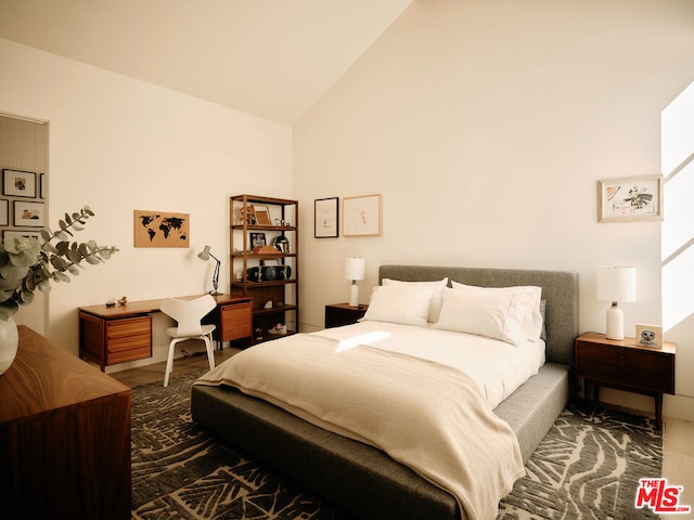 bedroom featuring high vaulted ceiling