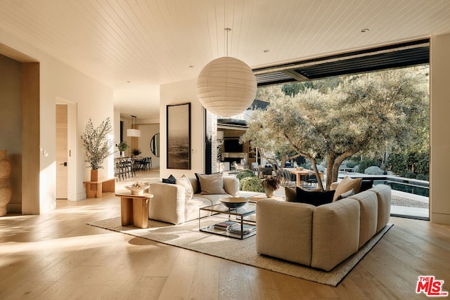 living room featuring wood ceiling, plenty of natural light, and light hardwood / wood-style floors