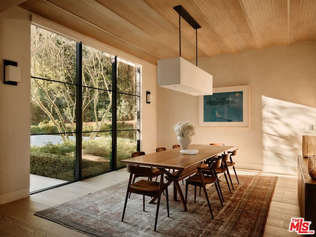 dining area with vaulted ceiling, wood ceiling, and light wood-type flooring