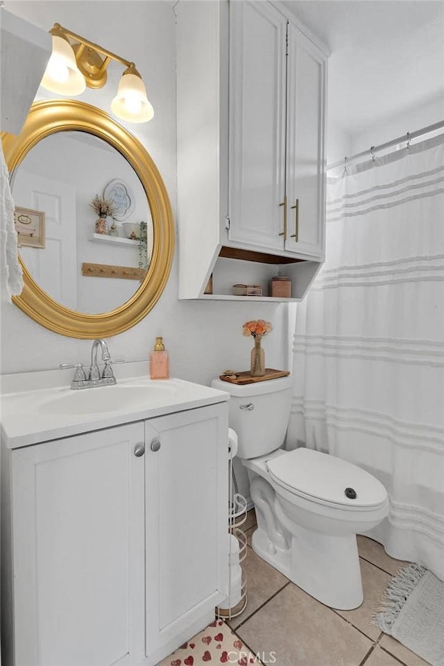 bathroom with tile patterned floors, toilet, and vanity