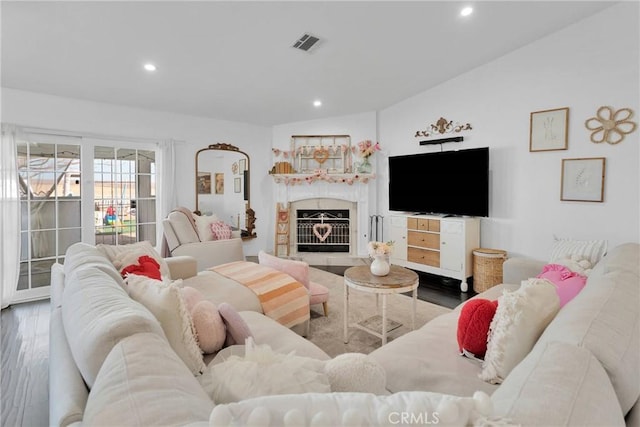 living room with hardwood / wood-style flooring and vaulted ceiling