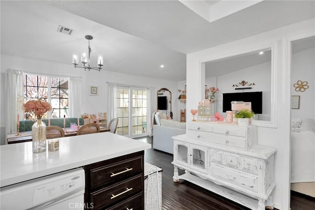 kitchen featuring a notable chandelier, decorative light fixtures, dark wood-type flooring, and dishwasher