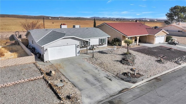 ranch-style house with a garage and a mountain view