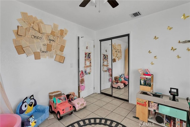 playroom with light tile patterned floors and ceiling fan