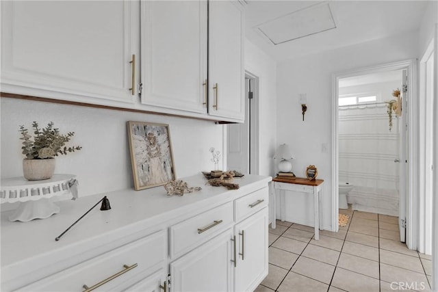 kitchen with white cabinetry and light tile patterned floors