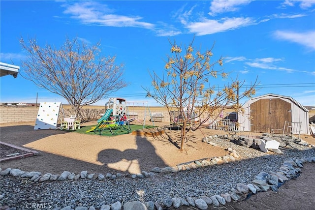 view of yard featuring a playground and a shed