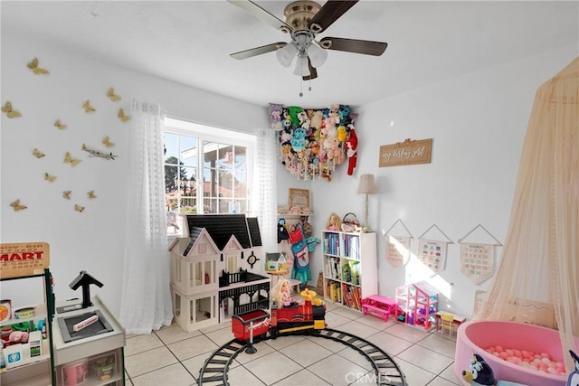 rec room with ceiling fan and light tile patterned floors