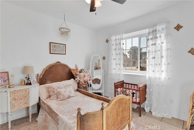 tiled bedroom featuring ceiling fan