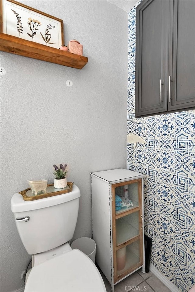 bathroom with tile patterned flooring and toilet