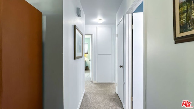 hallway featuring light carpet