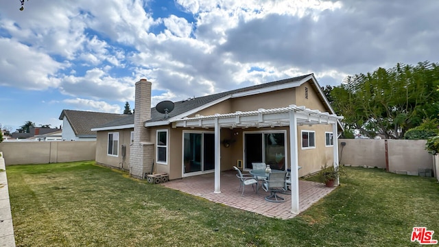 back of house with a lawn, a patio area, and a pergola