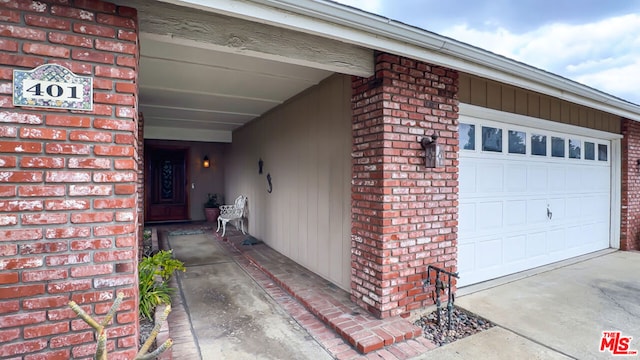 view of exterior entry with a garage