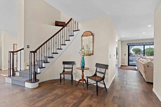 stairs featuring hardwood / wood-style floors